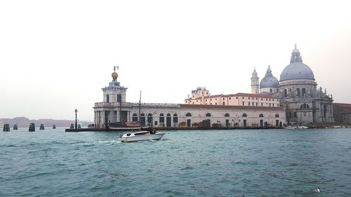 Boat in river with buildings in background