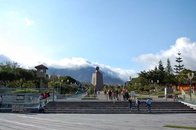 People at observation point against sky in city