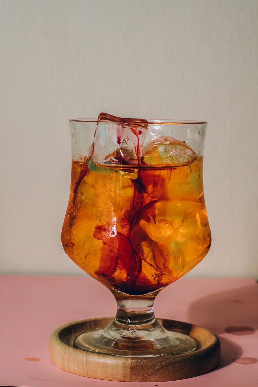 drink, refreshment, food and drink, distilled beverage, glass, alcoholic beverage, alcohol, household equipment, drinking glass, whisky, indoors, cold temperature, no people, studio shot, amber, yellow, soft drink, table, freshness, still life