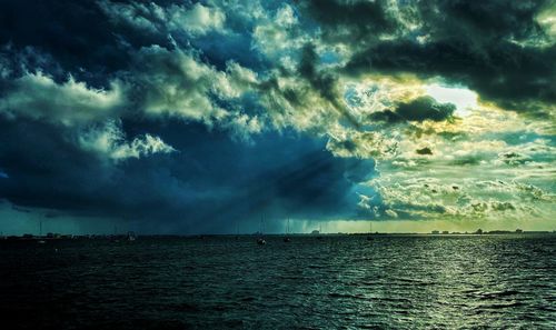 Scenic view of sea against storm clouds