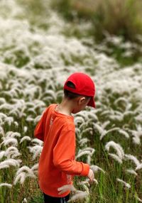 Side view of boy standing on field