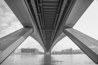 Low angle view of bridge over river in city