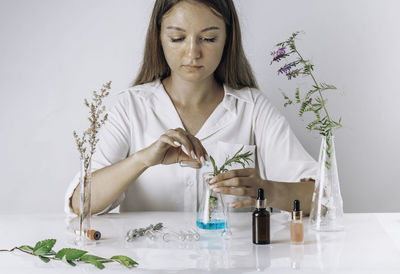 Woman working with cosmetic, scientist, doctor,  alternative herb medicine, organic in laboratory