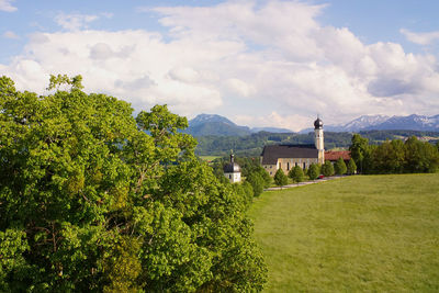 Scenic view of trees and buildings against sky