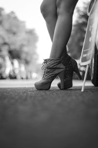 Low section of woman walking on street