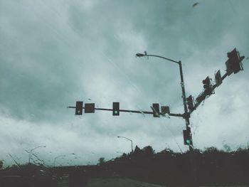 Low angle view of road sign against sky