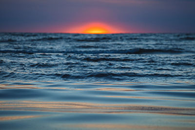 Scenic view of sea against clear sky at sunset