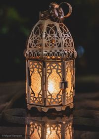 Close-up of illuminated lantern on table