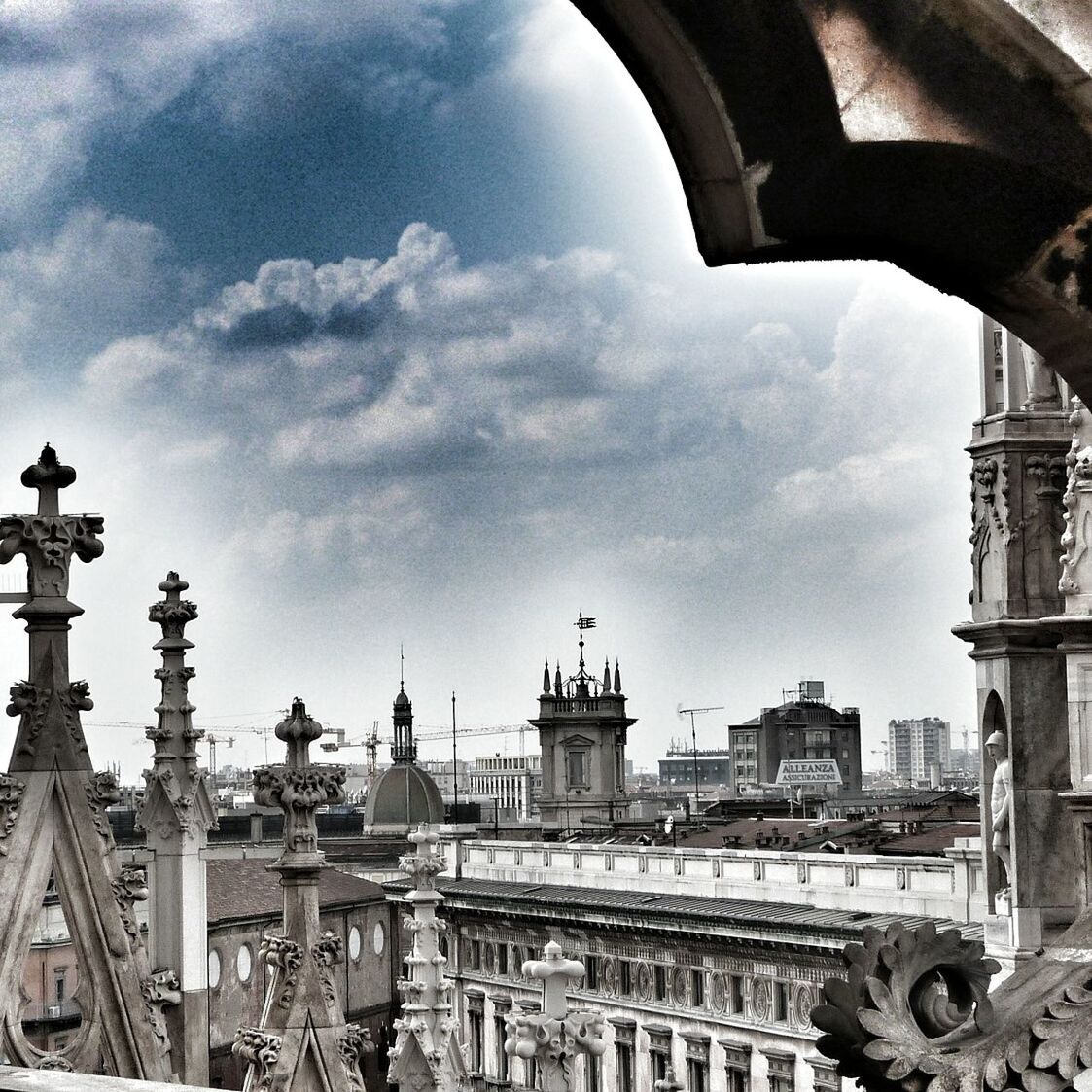 architecture, sky, building exterior, built structure, cloud - sky, city, cloud, day, tower, low angle view, cloudy, outdoors, incidental people, travel destinations, transportation, history, travel, land vehicle, cityscape, metal