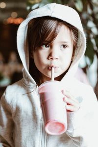 Portrait of cute girl drinking glass