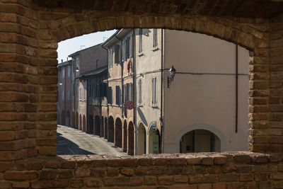 View from a window in the castle- main street, colonnade and houses in fontanellato in parma, italy.