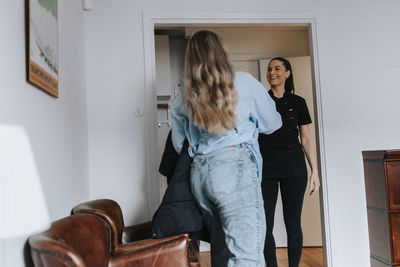 Female dentist with patient in waiting room