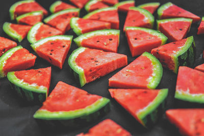 High angle view of fresh chopped watermelon pieces on table