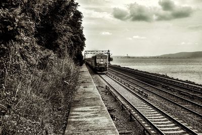 Train on railroad tracks against sky