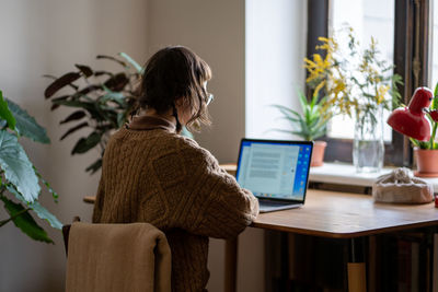 Young woman using laptop at home