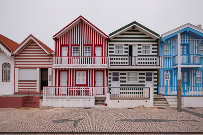 Houses in row against buildings in city