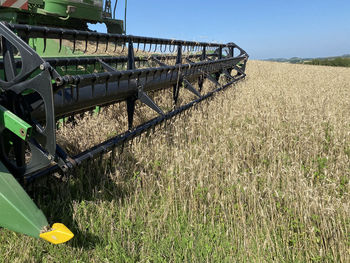 View of agricultural machinery on field against sky