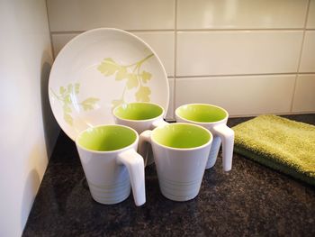 Cups and plate on kitchen counter