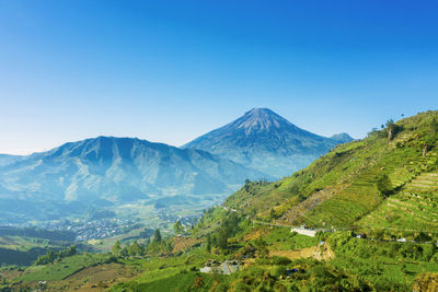 Scenic view of mountains against clear blue sky