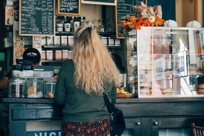 Rear view of woman standing in store