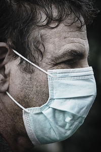 Close-up portrait of man wearing mask