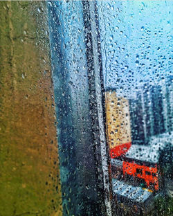 Full frame shot of wet glass window in rainy season