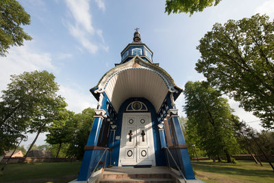 Low angle view of church against trees