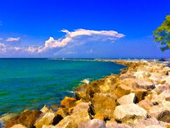 Scenic view of sea against cloudy sky