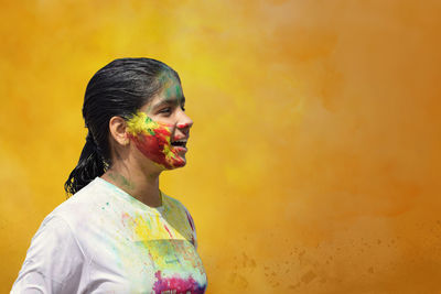 Cute girl with color on face celebrating holi festival