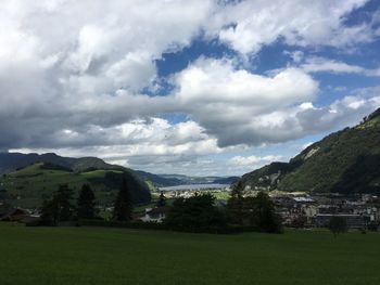 Scenic view of mountains against cloudy sky