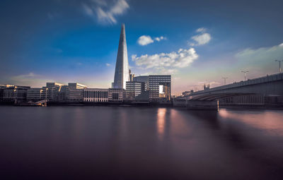 Bridge over river with buildings in background