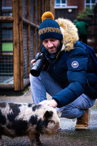 Portrait of man with pig