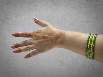 Close-up of woman hand on white wall