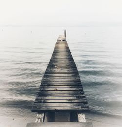 Pier over sea against clear sky