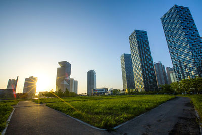 Modern buildings in city against clear sky