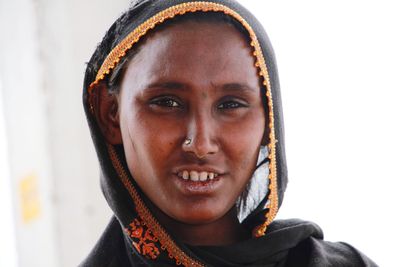 Close-up of smiling women against white background