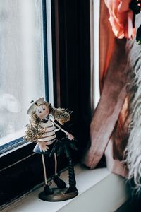 Midsection of woman with toy at home