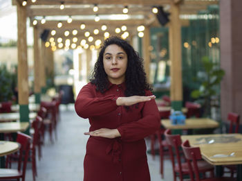 Portrait of young woman standing outdoors