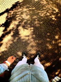 Low section of people standing on tiled floor