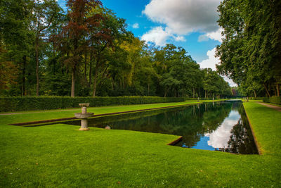 Scenic view of lake by trees against sky