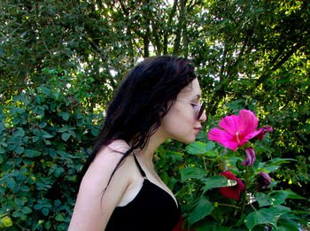 Woman smelling pink flower