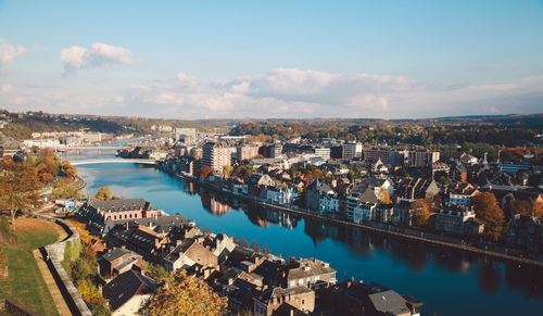 Aerial view of cityscape by sea against sky