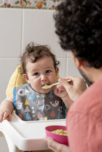 Boy child eating some baby food for lunch.