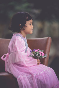 Woman holding pink flower