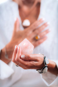 Self-esteem concept. hand holding a rose quartz crystal, boosting feeling of self-esteem