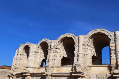 Low angle view of historical building against blue sky