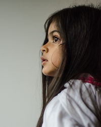 Close-up of young woman against white background