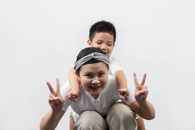 Portrait of happy boy against gray background