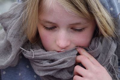 Close-up of blond girl wearing scarf