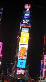 Low angle view of road sign at night